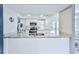Kitchen with granite countertops and stainless steel dishwasher with a view into the dining room at 6520 Pine Meadows Dr, Spring Hill, FL 34606
