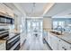Bright kitchen with stainless steel appliances, granite countertops, and a view into the breakfast nook at 6520 Pine Meadows Dr, Spring Hill, FL 34606