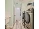 Laundry room features modern appliances and laminate flooring at 6520 Pine Meadows Dr, Spring Hill, FL 34606