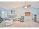Living room with vaulted ceiling, ceiling fan, carpet, wet bar, and comfortable seating at 6520 Pine Meadows Dr, Spring Hill, FL 34606