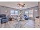Cozy living room with coastal decor, ceiling fan, and lots of natural light at 6520 Pine Meadows Dr, Spring Hill, FL 34606