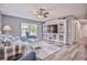 Comfortable living room with ceiling fan, coastal decor, and view of front yard at 6520 Pine Meadows Dr, Spring Hill, FL 34606