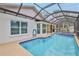 The screened-in pool includes a jacuzzi and seating at 6520 Pine Meadows Dr, Spring Hill, FL 34606