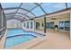 The screened-in pool features a jacuzzi-style add-on at 6520 Pine Meadows Dr, Spring Hill, FL 34606