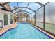 A full view of the screened-in pool featuring jacuzzi-style seating at 6520 Pine Meadows Dr, Spring Hill, FL 34606