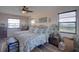 Main bedroom with king-size bed, tropical bedding, and wood floors at 6528 Louise Ct, Hudson, FL 34667