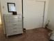 Bedroom with dresser and mirrored closet doors at 7240 Dogleg Ct, Port Richey, FL 34668
