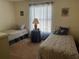 Bedroom with two twin beds and beach-themed decor at 7240 Dogleg Ct, Port Richey, FL 34668
