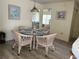 Bright dining area with glass-top table and four wicker chairs at 7240 Dogleg Ct, Port Richey, FL 34668
