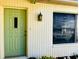 Charming light green front door with a window inset at 7240 Dogleg Ct, Port Richey, FL 34668