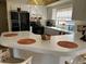 Kitchen with white cabinets, breakfast bar and black appliances at 7240 Dogleg Ct, Port Richey, FL 34668