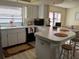 Galley kitchen with white cabinets and black appliances at 7240 Dogleg Ct, Port Richey, FL 34668