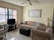 Cozy living room featuring a sofa, armchair, and TV at 7240 Dogleg Ct, Port Richey, FL 34668