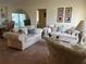 Spacious living room with two sofas and a coffee table at 7240 Dogleg Ct, Port Richey, FL 34668