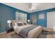 Relaxing bedroom with a king-size bed, blue walls, and modern decor at 7464 Acorn Cir, Spring Hill, FL 34606