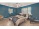 Serene bedroom with a king-size bed, blue walls, and a calming atmosphere at 7464 Acorn Cir, Spring Hill, FL 34606