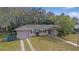 Exterior view of a single story home with a front yard at 7464 Acorn Cir, Spring Hill, FL 34606