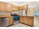 Bright kitchen features wood cabinets, stainless steel appliances, and ample counter space at 7464 Acorn Cir, Spring Hill, FL 34606