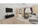 Living room with sectional sofa, TV, and coffee table at 7464 Acorn Cir, Spring Hill, FL 34606