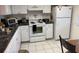 Galley kitchen with white cabinets and granite countertops at 7635 Bloomingdale Dr, New Port Richey, FL 34654