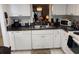 Kitchen with white cabinets, granite counters, and dishwasher at 7635 Bloomingdale Dr, New Port Richey, FL 34654
