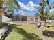 Spacious backyard with covered patio, playset, and fenced-in area at 807 Virginia Ave, Tarpon Springs, FL 34689