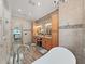Elegant bathroom with a freestanding tub, double vanity, and walk-in shower at 807 Virginia Ave, Tarpon Springs, FL 34689