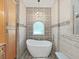 Relaxing bathroom with a modern freestanding tub and decorative tile at 807 Virginia Ave, Tarpon Springs, FL 34689