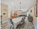 Bright dining room features a large table and chandelier, hardwood floors, and an open floor plan at 807 Virginia Ave, Tarpon Springs, FL 34689