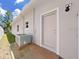 Exterior view of home showing AC unit and exterior door at 807 Virginia Ave, Tarpon Springs, FL 34689