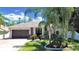 House exterior showcasing a two-car garage and manicured lawn at 807 Virginia Ave, Tarpon Springs, FL 34689