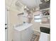 Laundry room with washer, dryer, and ample shelving for storage at 807 Virginia Ave, Tarpon Springs, FL 34689