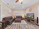 Comfortable living room with brown sectional sofa and large TV at 807 Virginia Ave, Tarpon Springs, FL 34689