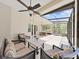 Spacious screened porch with seating area and ceiling fans at 807 Virginia Ave, Tarpon Springs, FL 34689