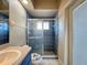 Clean bathroom with blue tile, shower, and single sink vanity at 8284 Cockatoo Rd, Weeki Wachee, FL 34613