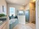 Bathroom with corner bathtub and walk-in shower at 8284 Cockatoo Rd, Weeki Wachee, FL 34613