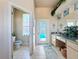 Bathroom with dual sinks, a tub, a shower, and a toilet at 8284 Cockatoo Rd, Weeki Wachee, FL 34613
