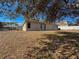 Tan house exterior with a large backyard at 8284 Cockatoo Rd, Weeki Wachee, FL 34613