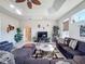 Spacious living area featuring sectional sofa and a cozy fireplace at 8284 Cockatoo Rd, Weeki Wachee, FL 34613