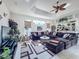 Spacious living room featuring a large sectional sofa and access to the kitchen at 8284 Cockatoo Rd, Weeki Wachee, FL 34613