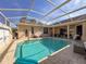 Beautiful screened pool with ocean mural and comfortable seating at 8284 Cockatoo Rd, Weeki Wachee, FL 34613