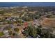 Aerial view of a single-Gathering home in a residential area near a golf course at 905 Palm Blvd, Dunedin, FL 34698