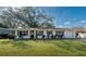 Front view of a ranch home, featuring a neat lawn and garage at 905 Palm Blvd, Dunedin, FL 34698