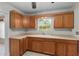 Kitchen boasts oak cabinets and a large sink at 905 Palm Blvd, Dunedin, FL 34698