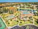 Aerial view of community amenities including pool, clubhouse, and shuffleboard at 9240 Tiara Ct, New Port Richey, FL 34655