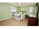Bright bedroom with wood floors and a decorative metal bed frame at 9240 Tiara Ct, New Port Richey, FL 34655