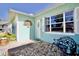 Inviting front entrance with a decorative wreath and charming bench at 9240 Tiara Ct, New Port Richey, FL 34655