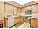 Bright kitchen with stainless steel appliances and wood cabinets at 9240 Tiara Ct, New Port Richey, FL 34655