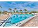 Community pool with surrounding patio and palm trees at 9240 Tiara Ct, New Port Richey, FL 34655