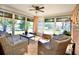 Relaxing sunroom with wicker furniture and lake view at 9240 Tiara Ct, New Port Richey, FL 34655